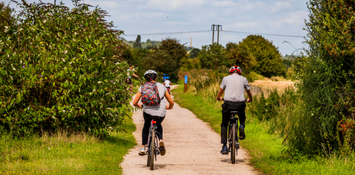 This image: an illustrative photograph of two people cycling along a foliage-lined path 
					 	on a sunny day.
						The map: The map shows illustrative arrows representing the different types of cycling and 
						walking connections in the draft Development Framework. There are interactive markers showing 
						more detail when clicked on.
